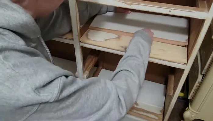 Sand down the wood to prepare for painting. Consider using an electric sander for efficiency.