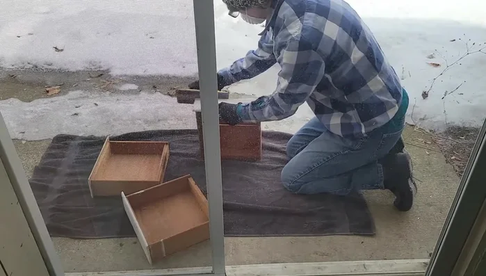 Sand down the wood to prepare for painting. Consider using an electric sander for efficiency.