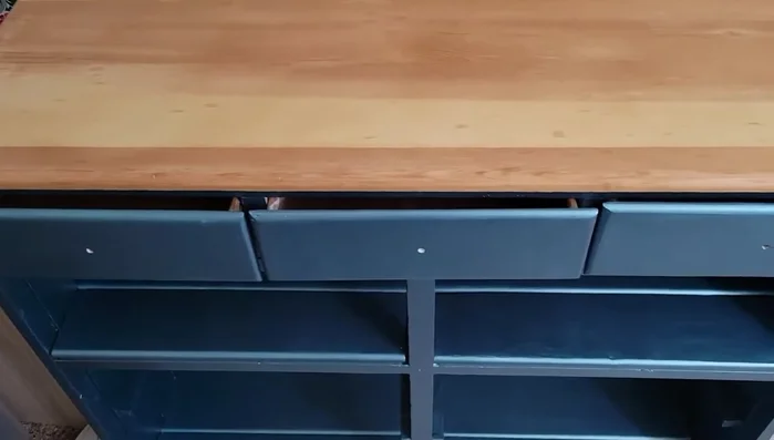 Attach new knobs to the drawers.