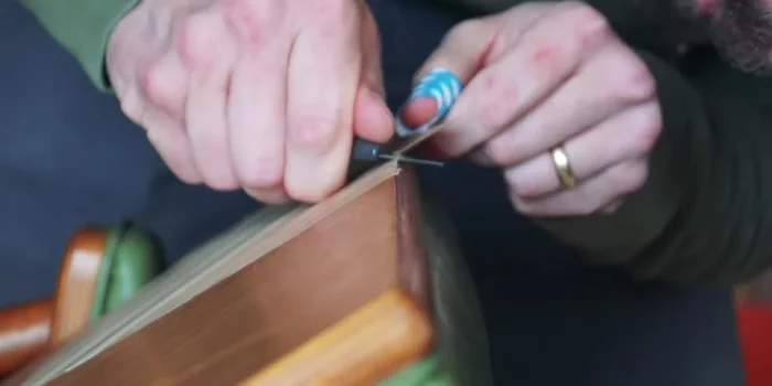 Cut away any excess veneer, ensuring a flush fit with the chair.