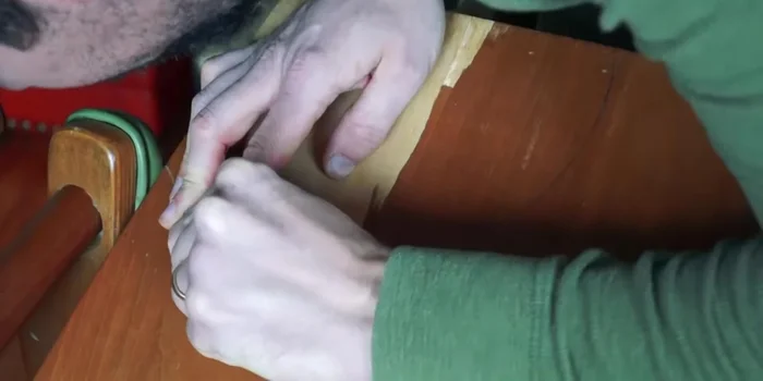 Trace and cut a circle (or desired shape) on the damaged area of the chair's lamination.