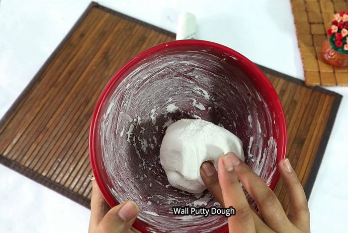 Mix wall putty: Mix one cup of wall putty with half a cup (or less) of water to create a smooth paste.