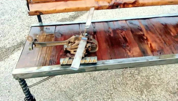 Helicopter-inspired bench with snow chain and rebar