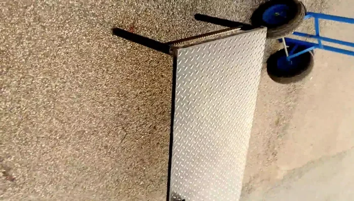 End table with saw blades, plow disc, and rebar