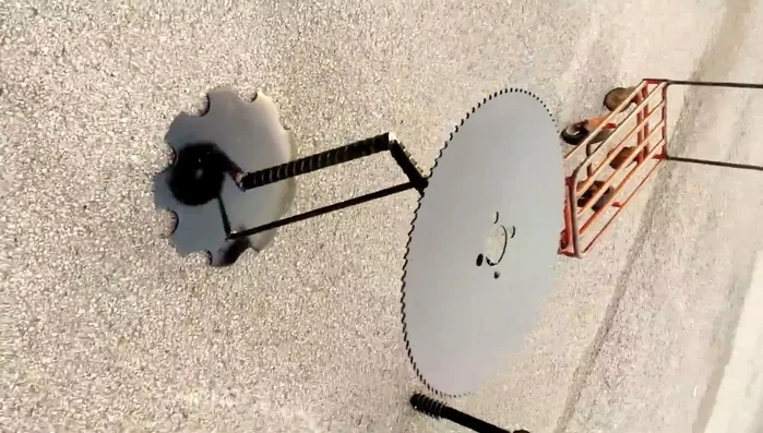 End table with saw blades, plow disc, and rebar