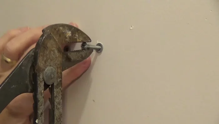 For drywall: Use pliers to pull the anchor out.