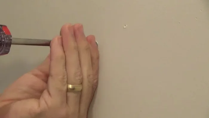 Remove screws from the wall anchors, leaving the anchors themselves in the wall.