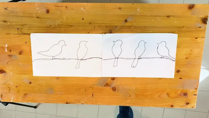 Secure the drawing: Stick the drawing onto your working table using masking tape to prevent it from moving.