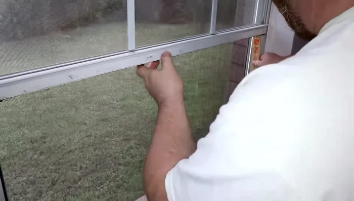 Pry open the window to access the balance spring mechanism.