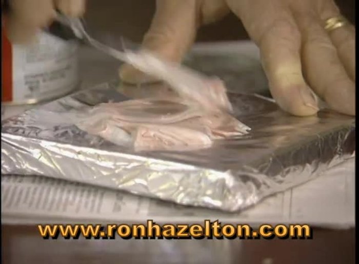 Prepare the damaged area by applying tape around the edges to prevent filler spillage.