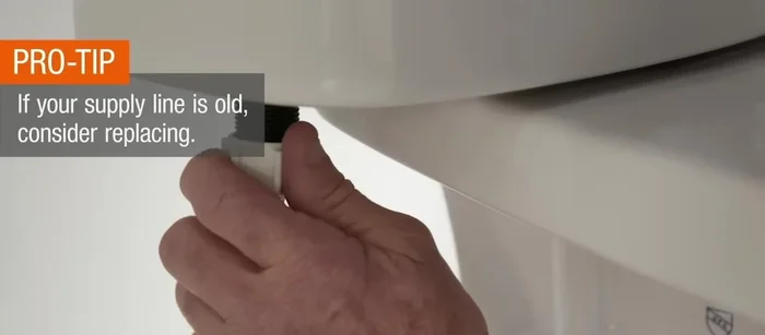 Reattach the supply line nut, and attach the fill valve tube to the overflow tube. Turn the water supply back on.