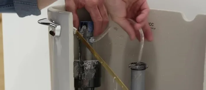 Reattach the supply line nut, and attach the fill valve tube to the overflow tube. Turn the water supply back on.