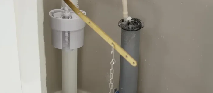 Adjust the chain length as needed, and replace the toilet tank lid.