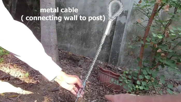 Attach the metal cable to the sling and posts.