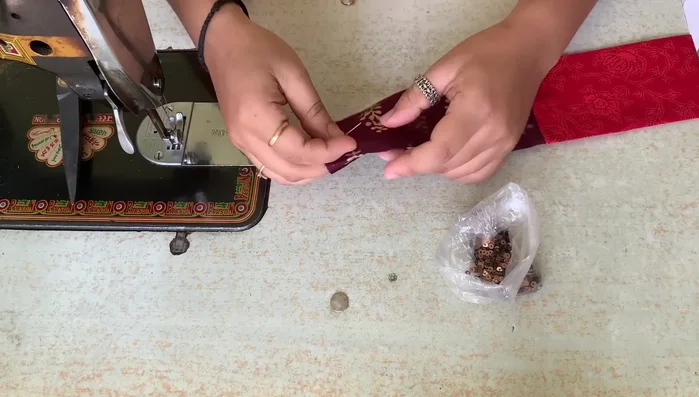 Finish the corners: The video shows a technique for neatly finishing the saree corners with the gota, avoiding pleats and maintaining clean stitching.