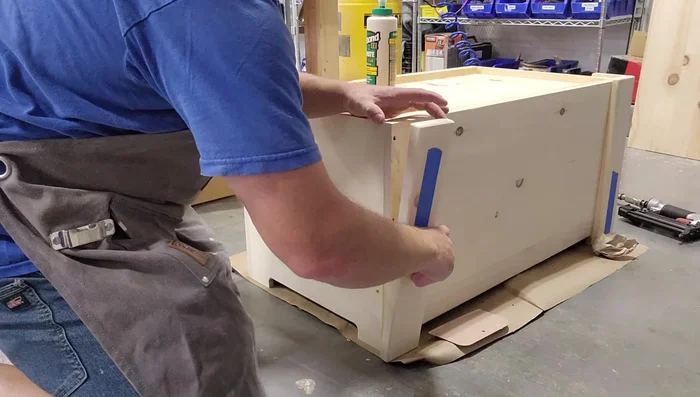 Attach legs (glue and brad nails, use spacers for even gap, consider using a router to trim flush with box top).