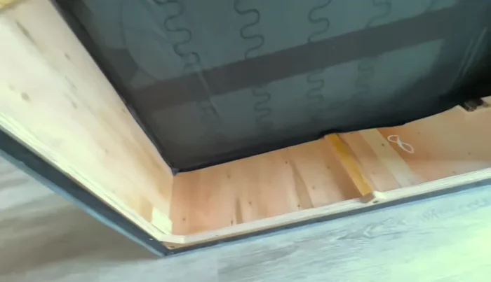 Inspecting the internal construction of the base, seat cushions, and armrests.