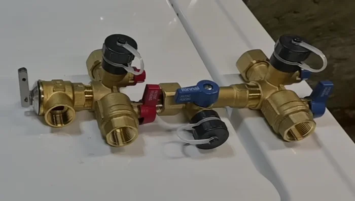 Install the Rai valve kits (hot and cold water lines), using thread tape and pipe dope.