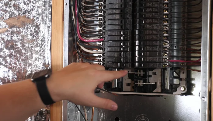 Release the breaker by pulling it forward. There's a clip holding it to the bar.