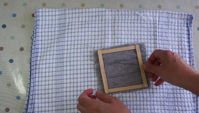 Prepare the frame: Attach cheesecloth or thin fabric to a frame using clips or a stapler, ensuring the fabric is taut.
