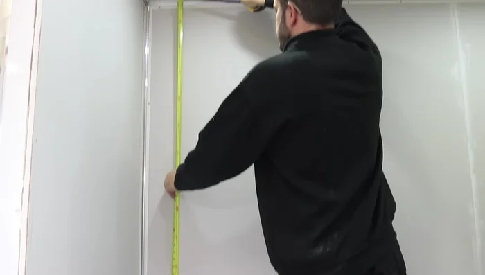 Apply silicone to the back of the panel (side to side if walls are uneven) and add it to the wall, pushing it into the internal trim.