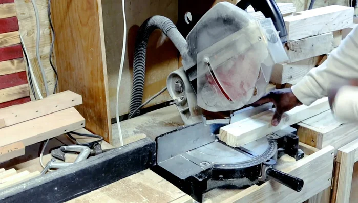 Adding bevels to the bottoms of the legs using a sander.