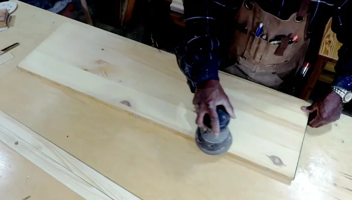 Sanding the tabletop.