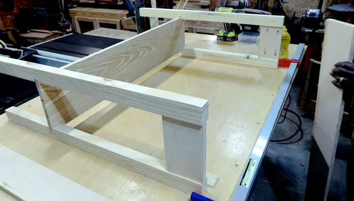 Assembling the console table: adding the bottom shelf and side skirts. Using a quarter-inch plywood spacer to create a reveal.