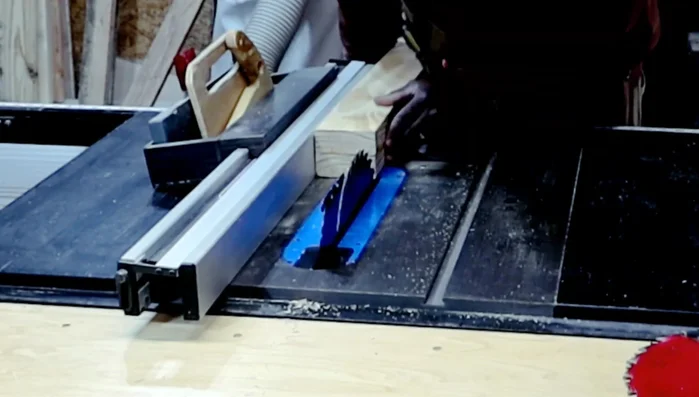 Adding bevels to the bottoms of the legs using a sander.