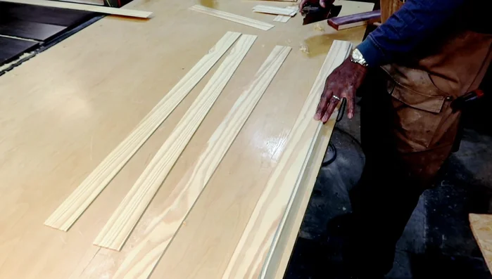 Laminating the face, back, and sides of the console table using additional pieces of wood, trimming the edges and light sanding.