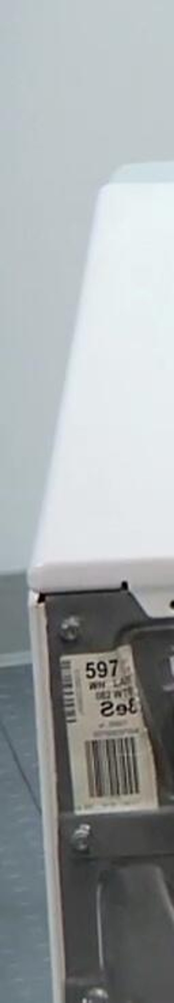 Remove the top panel. Remove three screws across the back of the machine and lift off the top panel.