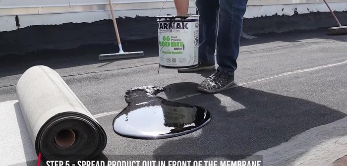 Re-roll the membrane into the adhesive to secure it.