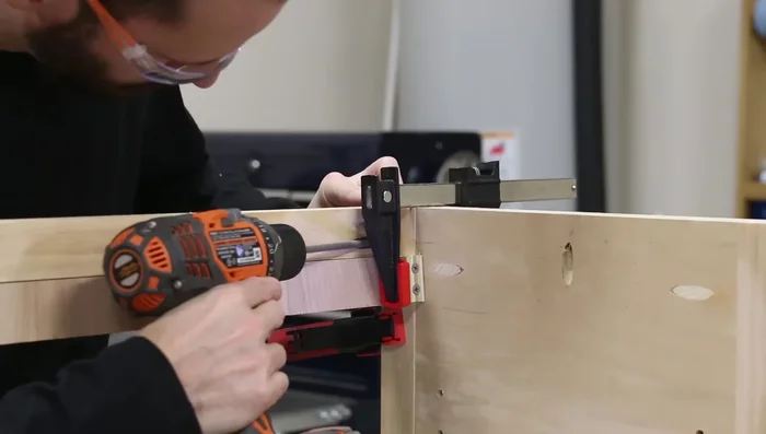 Assemble the base: Attach front and back stretchers, then the lower shelf, ensuring even spacing.