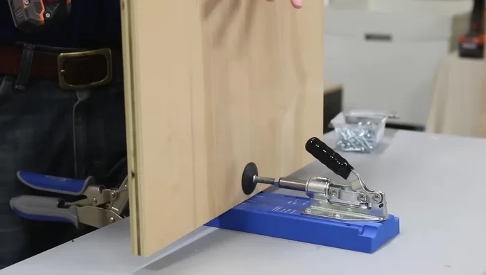 Attach side panels to the frame using pocket holes and shims (playing cards) to ensure flushness.