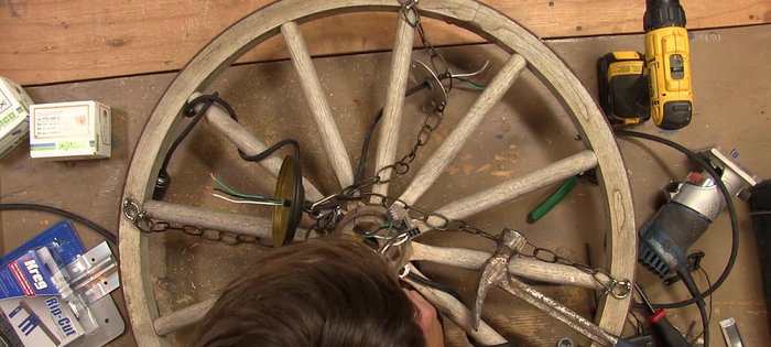 Wrap each spoke with wire, attach retro style sockets, and install vintage Edison style bulbs.