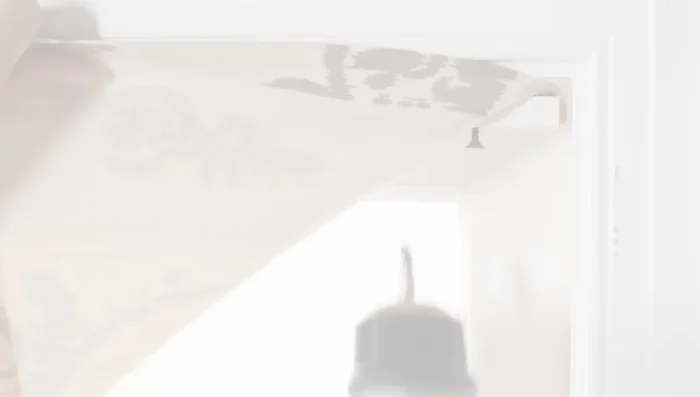 Screw dowel into window frame to hang shade.