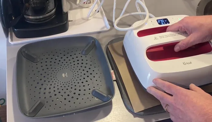 Attach the design to the tabletops using a heat press.