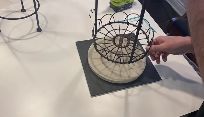 Attach the tabletops to the plant stands using screws.