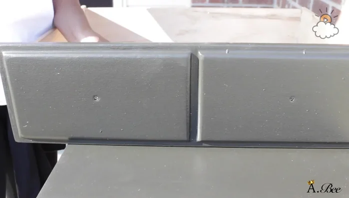 Clean the dresser with a microfiber towel and Windex.