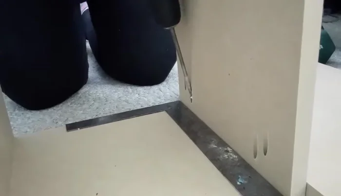 Install the middle section: Lift the assembled middle shelf section into place within the closet.