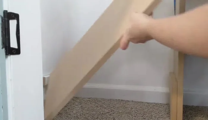 Build the shoe shelves: For wall-side bottom shelf, attach a small board directly to the wall. For other shelves, use MDF supports, position the shelf boards, and secure them with a nail gun.