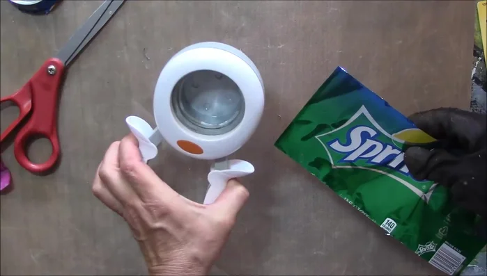 Use a 2-inch hole punch to create uniform circles from the cut aluminum.