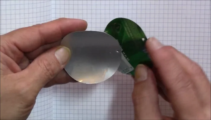 Attach the aluminum circles to split rings, ensuring opposite sides (printed and silver) are facing out.