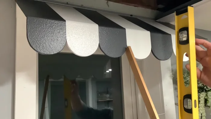 Install the awning on the window frame.