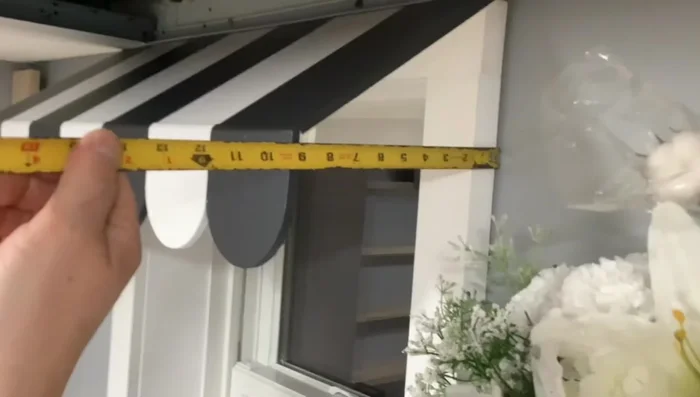 Attach the two smaller support pieces to the sides and the top of the awning.