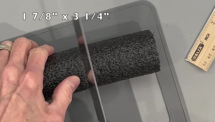 Cut slits in the fabric, glue to the pipe insulation on both ends, and attach felt circles.