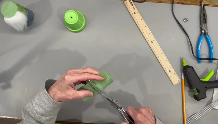 Attach the gloves to the gnome's arms.