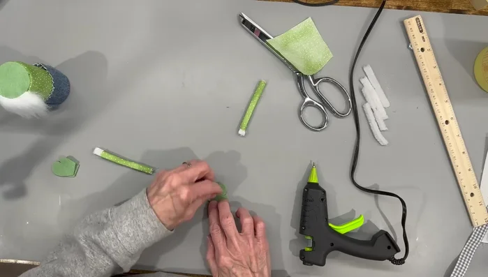 Attach the gloves to the gnome's arms.