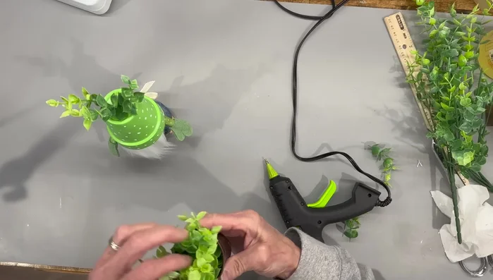 Add greenery and gardening tools.