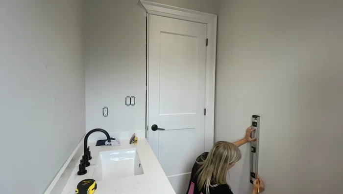 Mark the wall: Use a level to draw a vertical line on the wall to guide the placement of the first panel.